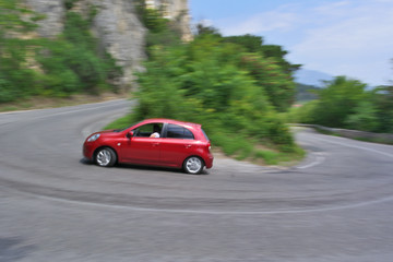 Fototapeta na wymiar Drifting red car on the road