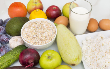 vegetables and fruits ,   healthy food, avocado, plums, onions, garlic, apples,  cheese, milk, bacon, zucchini, dried fruits, tomatoes, lemon, oat flakes,