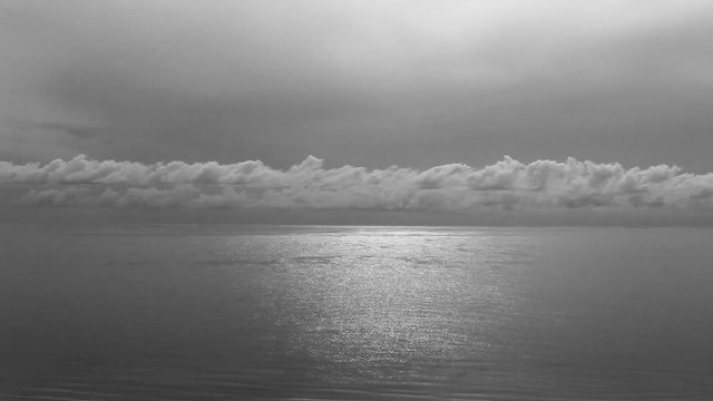 Beautiful sunset over sea of Thailand in black and white photo.