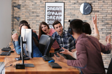 Young people playing video games at tournament