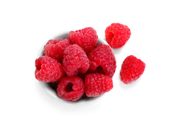 Bowl with ripe raspberries on white background