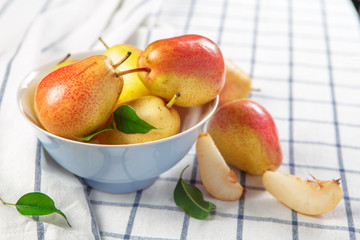 organic pears laying down on a lightly dotted kitchen cloth