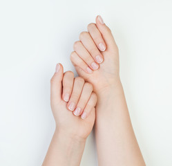Obraz na płótnie Canvas Beautiful female hands together on white background. Manicure concept