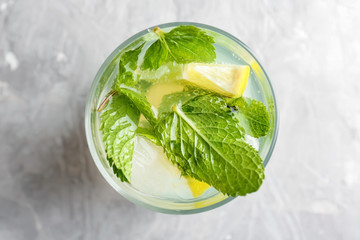 Glass of fresh mojito on light table