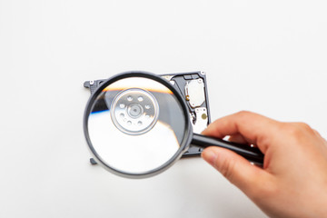 A hard disk drive under magnifying glass.