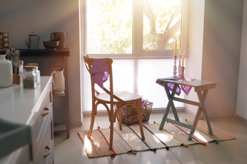 Cozy place for rest with chair and table near window in kitchen