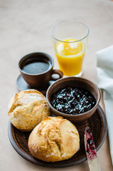 Simple breakfast: coffee americano, fresh buns with jam and juice.