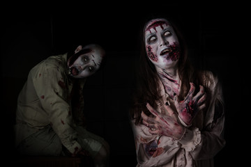 Two scary zombie in darkroom ,people make up for Halloween.