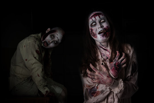 Two scary zombie in darkroom ,people make up for Halloween.