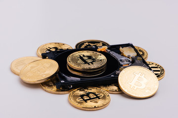Closeup of gold bitcoins on a hard disk drive.