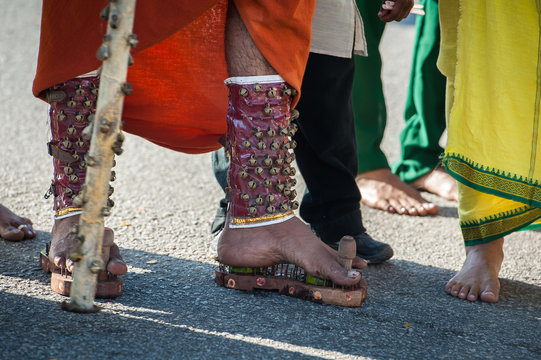 Thaipusam devotee in Penang wearing spiky shoes in penance