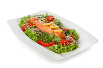Plate with tasty salmon and fresh salad on white background