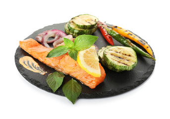 Slate plate with tasty salmon and vegetable salad on white background