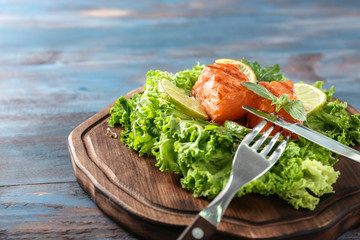 Healthy fresh salad with salmon on wooden board