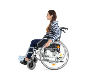 Young woman sitting in wheelchair on white background