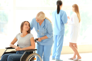 Obraz premium Handicapped young woman with mature female doctor in clinic
