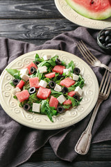 Plate with delicious watermelon salad on table