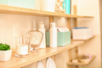 Fototapeta na wymiar Body care accessories on shelf in bathroom
