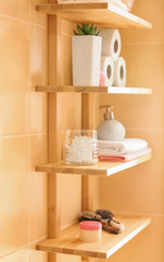 Fototapeta na wymiar Bath accessories on wooden shelves