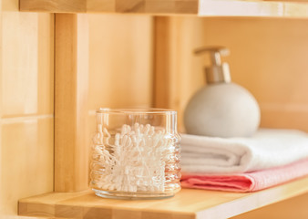 Fototapeta na wymiar Bath accessories on wooden shelf