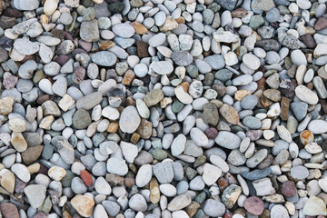 Fine pebbles of a gray shade. Beach ground. Natural material for design, decoration and construction. Sanded granite and hard minerals. Geology and minerals. Tutorial.
