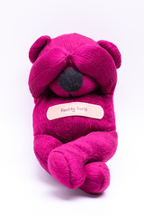 Reality hurts. Pink teddy bear covering eyes with hands. Escape from reality.