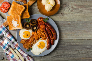Full English breakfast, with sausage, mushrooms, beans and a fried egg.