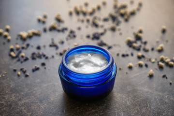 Jar with body cream on grey table