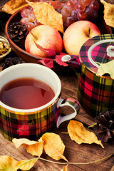 Cup of tea with autumn leaves