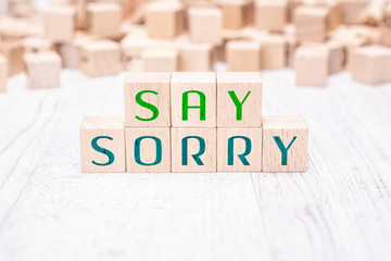 The Words Say Sorry Formed By Wooden Blocks On A White Table