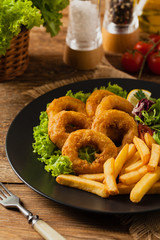 Roasted squid rings with fries.