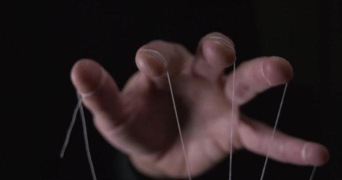 Puppet hand with string tied around fingers