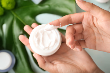 Woman holding jar of natural cream, closeup