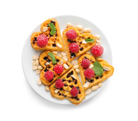 Heart shaped waffles with raspberries and nuts on white background