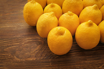 Ripe juicy lemons on wooden table
