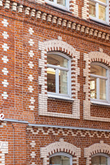 Windows in a beautiful house, with neat brickwork of white and red brick