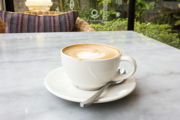 Hot latte on a marble table.