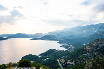 aerial view of Budva riviera, Adriatic sea and mountains during sunset in Montenegro