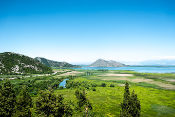 Fototapeta na wymiar beautiful view of green valley, lake and mountains in Montenegro