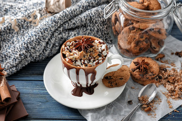 Cup of hot chocolate with marshmallows and cookies on wooden table