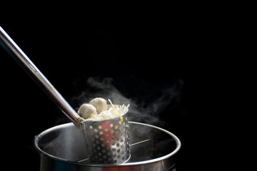 Noodle blanched in basket with hot smoke and steam.