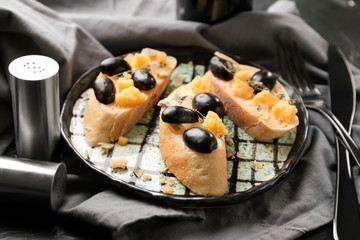 Tasty sandwiches with cheese and grape on plate