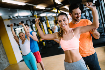 Beautiful woman helped by trainer