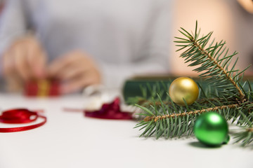 Beautiful women preparing christmas presents. Holiday and christmas concept. Wrapped christmas gifts.