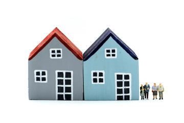Miniature people: Couple of Oldmans standing with house, money saving growth. Retirement, emergency plan and Financial Concept.