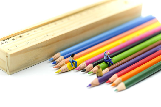 Miniature people : Businessman sitting on Color pencils,Business Education concept.