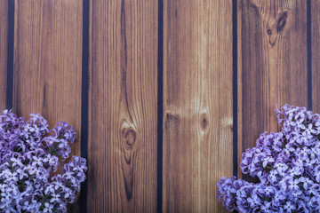 bright lilac flowers on a beautiful wooden background with copy space.