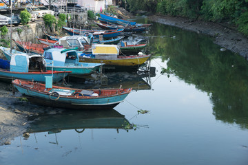 Fototapeta na wymiar Thai traditional fishing boats park at the canal that connect to Sattihip Bay in a morning day