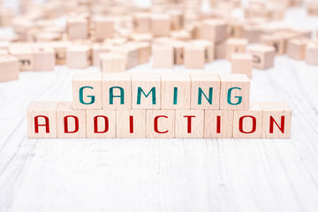 The Words Gaming Addiction Formed By Wooden Blocks On A White Table