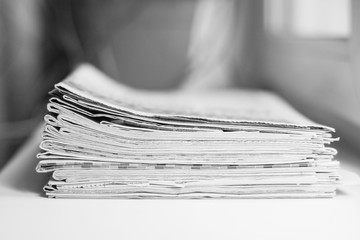 Pile of newspapers, folded and stacked journals. Papers with news (headlines and articles),...